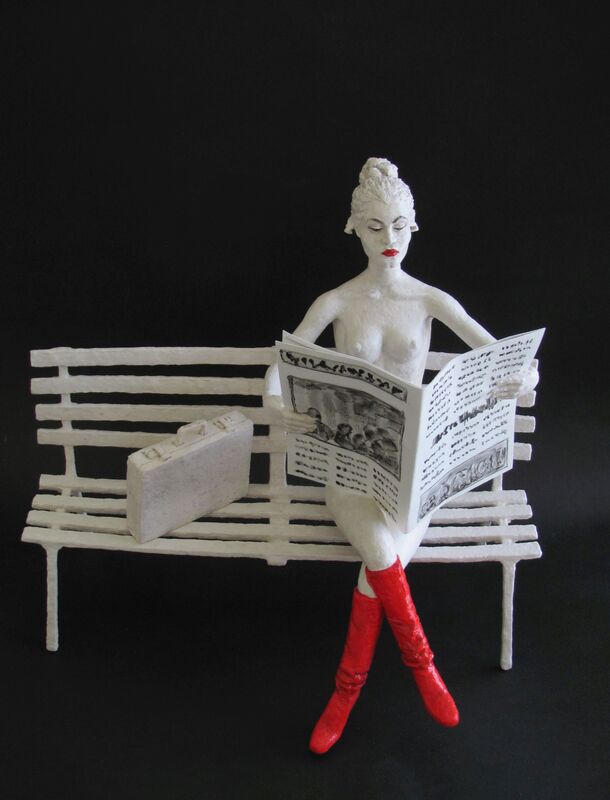 sculpture of a woman reading the newspaper