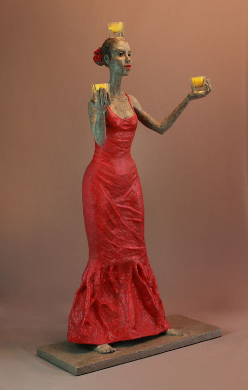 sculpture of a woman with candles in hand
